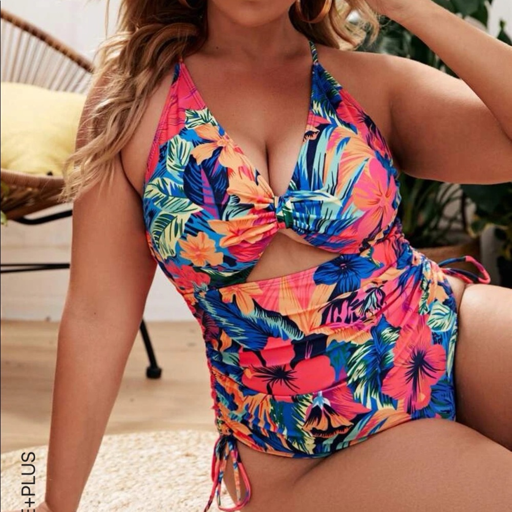 Tropical one-piece swimsuit with drawstring sides and back.